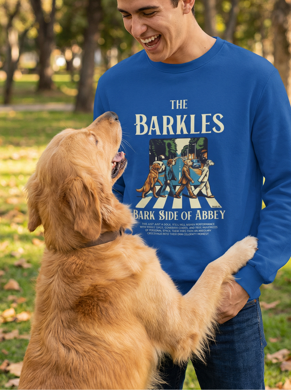 Man wearing blue Bark Side of Abbey dog lover pullover laughing with dog