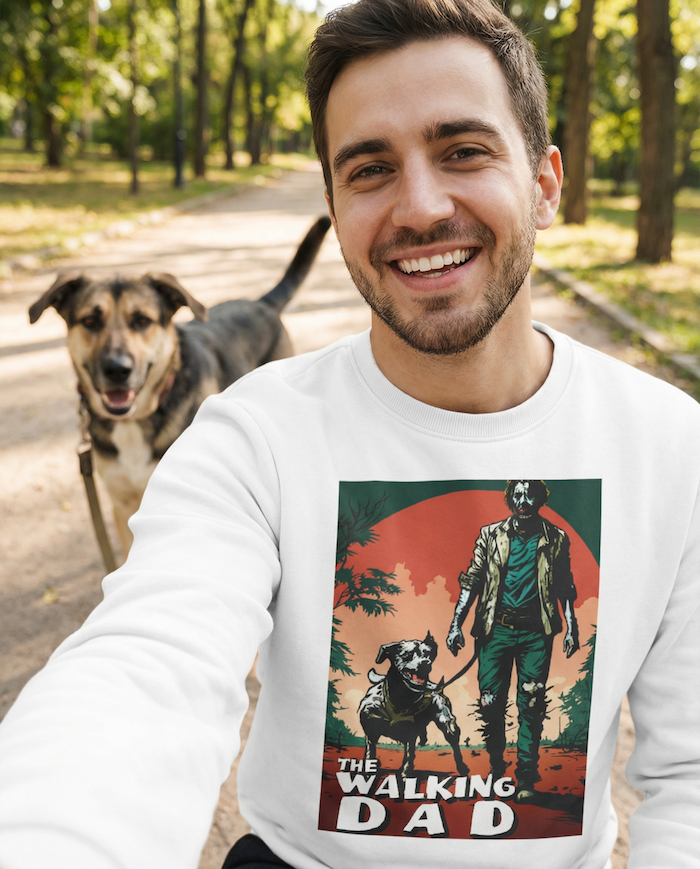 Man smiling while walking his dog outdoors wearing a PAWR The Walking Dad dog sweatshirt with a cinematic dog-walking graphic, perfect for dog dads, dog lovers, and everyday casual wear.